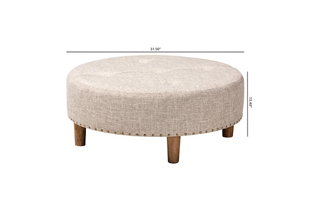 Chic and versatile, this ottoman is designed for the modern home. Upholstered in a soft polyester fabric that displays a subtle cross-hatch weave for a natural earthy feel. The neutral upholstery is complemented by sturdy wood legs showcasing the rustic beauty of the woodgrains. Button tufting on the top and brass-tone nailhead trim along the lower edge add a touch of elegance. Use this versatile ottoman as a coffee table, footstool or extra seating for guests as the need arises.Engineered wood frame | Solid wood legs with natural finish | Beige polyester upholstery | Assembly required