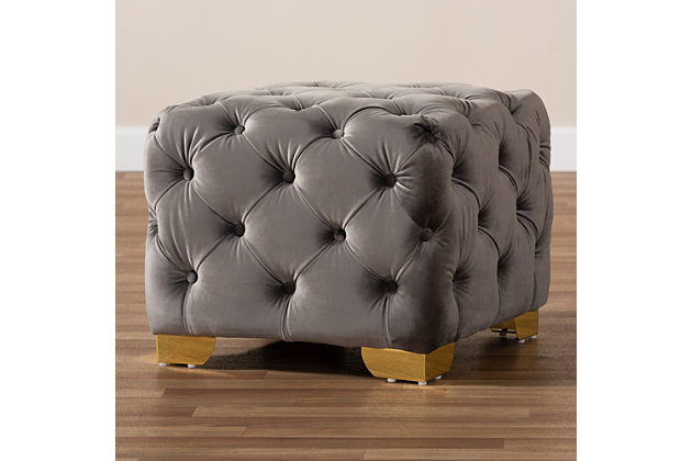 Raise your standard of living with this ottoman upholstered in a soft, sumptuous velvet fabric. Reserved exclusively for those with a penchant for high-glam home decor, this ultra-chic ottoman is dressed to impress with all over button tufting and lustrous goldtone-finished metal feet that simply works. Easy on the eyes and alluring to the touch, this decidedly elegant and versatile ottoman can be used as a coffee table, footstool or as extra seating for guests.Engineered wood frame | Metal feet | Gray velvet upholstery | No assembly required