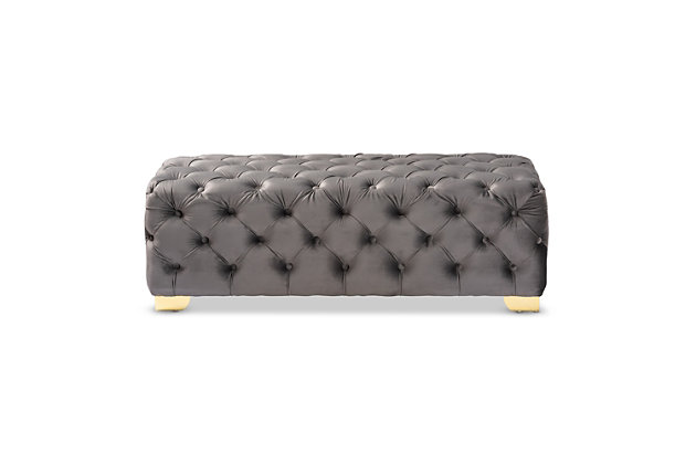 Raise your standard of living with this ottoman bench upholstered in a soft, sumptuous velvet fabric. Reserved exclusively for those with a penchant for high-glam home decor, this ultra-chic bench is dressed to impress with all-over button tufting and lustrous goldtone finished metal feet that simply work. Easy on the eyes and alluring to the touch, this decidedly elegant and versatile bench can be placed anywhere from the entryway to the foot of the bed.Engineered wood frame | Metal feet | Gray velvet upholstery | No assembly required