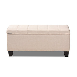 This modern ottoman displays a simple, streamlined design that makes it complementary to a wide range of decor styles. Upholstered in a soft, neutral fabric, the lid is foam padded and biscuit tufted to provide the utmost comfort. The ottoman features a large compartment under the lid, providing space to store extra blankets and pillows. Finished wood feet complete the look. Versatile enough to use as both seating and storage in the entryway, living room or bedroom.Beige polyester upholstery | Lift-top storage compartment | Wood feet with black finish | Assembly required