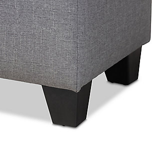 This modern ottoman displays a simple, streamlined design that makes it complementary to a wide range of decor styles. Upholstered in a soft, neutral fabric, the lid is foam padded and biscuit tufted to provide the utmost comfort. The ottoman features a large compartment under the lid, providing space to store extra blankets and pillows. Finished wood feet complete the look. Versatile enough to use as both seating and storage in the entryway, living room or bedroom.Gray polyester upholstery | Lift-top storage compartment | Wood feet with black finish | Assembly required