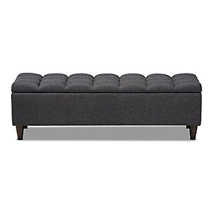 This chic ottoman features a streamlined design that makes it easy to coordinate with a wide range of decor styles. Upholstered in a soft, durable polyester fabric, the lid is foam padded and biscuit tufted to provide the utmost comfort. A large compartment under the lid provides space to store extra blankets and pillows, while the tapered wood legs add mid-century modern appeal. Use this versatile piece in the entryway, living room or bedroom.Gray/beige polyester upholstery | Lift-top storage compartment | Wood legs with dark brown finish | Assembly required