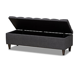 This chic ottoman features a streamlined design that makes it easy to coordinate with a wide range of decor styles. Upholstered in a soft, durable polyester fabric, the lid is foam padded and biscuit tufted to provide the utmost comfort. A compartment under the lid provides space to store extra blankets and pillows, while the tapered wood legs add mid-century modern appeal. Use this versatile piece in the entryway, living room or bedroom.Gray/beige polyester upholstery | Lift-top storage compartment | Wood legs with dark brown finish | Assembly required