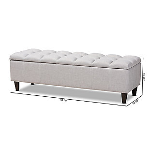 This chic ottoman features a streamlined design that makes it easy to coordinate with a wide range of decor styles. Upholstered in a soft, durable polyester fabric, the lid is foam padded and biscuit tufted to provide the utmost comfort. A large compartment under the lid provides space to store extra blankets and pillows, while the tapered wood legs add mid-century modern appeal. Use this versatile piece in the entryway, living room or bedroom.Charcoal polyester upholstery | Lift-top storage compartment | Wood legs with dark brown finish | Assembly required