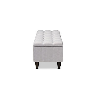 This chic ottoman features a streamlined design that makes it easy to coordinate with a wide range of decor styles. Upholstered in a soft, durable polyester fabric, the lid is foam padded and biscuit tufted to provide the utmost comfort. A large compartment under the lid provides space to store extra blankets and pillows, while the tapered wood legs add mid-century modern appeal. Use this versatile piece in the entryway, living room or bedroom.Charcoal polyester upholstery | Lift-top storage compartment | Wood legs with dark brown finish | Assembly required