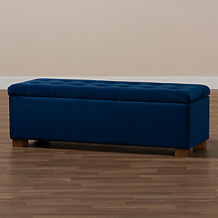 Perfect as a bed end bench for your bedroom or as an accent piece in your living space, the Roanoke storage bench combines handy seating and storage in a stylish way. Constructed with rubberwood, the bench features a cushioned seat upholstered in a soft blue velvet fabric that adds a dose of glamour to your space. The elegant grid-tufted top opens to reveal ample storage space, while walnut brown legs create a strong foundation.Contemporary style | Walnut brown legs | Made of rubberwood, engineered wood, polyester and foam | Upholstered in blue velvet polyester fabric; foam padding | Lift-top storage compartment | Imported | Requires leg assembly