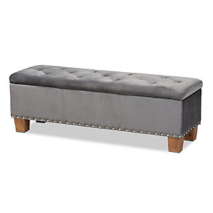 For hidden storage that doubles as seating, opt for the Hannah storage bench. Constructed with rubberwood, the bench is upholstered in a soft gray velvet fabric that adds a dose of glamour to your space. The elegant button-tufted top is padded with foam for seating comfort and opens to reveal ample storage space for extra blankets and linens. Silvertone nailhead trim and walnut-finished block feet lend a chic, modern look. The Hannah is well suited for use as a bed end bench in your bedroom or as an accent piece in your living room.Contemporary style | Made of rubberwood, engineered wood, polyester and foam | Walnut brown legs | Upholstered in gray velvet polyester fabric; foam padding | Lift-top storage compartment | Imported | Requires leg assembly