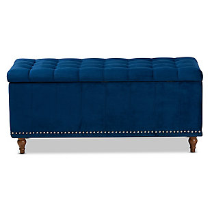 Whether it's placed in the bedroom or living room, the versatile Kaylee bench offers elegant style and handy storage space. Constructed with rubberwood, this storage bench is upholstered in a soft blue velvet fabric that adds a dose of glamour to your space. The top is padded with foam for seating comfort, and opens to reveal ample storage space for extra blankets and linens. Silvertone nailhead trim and grid stitching lend a modern look, while button tufting and turned feet add a refined elegance.Contemporary style | Walnut brown legs | Made of rubberwood, engineered wood, polyester and foam | Upholstered in blue velvet polyester fabric; foam padding | Lift-top storage compartment | Imported | Requires leg assembly