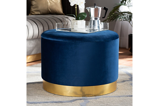 Maximize your storage capacity in the most glamorous way with the glam Marisa ottoman. Padded with foam for the utmost comfort, it features a removable lid that reveals ample storage space. Sleek blue velvet fabric upholstery feels exceptionally soft to the touch and complements the striking goldtone finish on the base. This chic piece is well suited for use as a footstool or extra seating.Contemporary style | Goldtone base | Made of engineered wood, metal, polyester and foam | Upholstered in blue velvet polyester fabric; foam padding | Imported | Arrives fully assembled