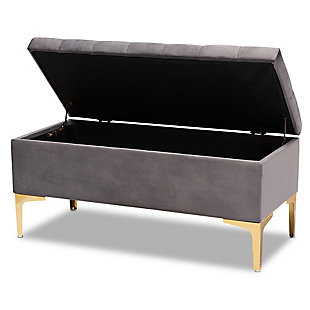 Glamorous seating doubles as practical storage in the Valere ottoman. Constructed from oak wood, the Valere is upholstered in a lavish gray velvet fabric and padded with foam for the utmost sitting comfort. The elegant button-tufted top opens to reveal ample storage space, while goldtone legs add a striking look. The Valere is well suited for use as a bench in a bedroom, or as an accent piece in the living room.Contemporary style | Made of oak wood, polyester and foam | Goldtone legs | Upholstered in gray velvet polyester fabric; foam padding | Lift-up storage compartment | Imported | Assembly required
