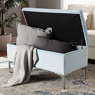 With its functional utility and luxurious style, the Mabel ottoman meets a variety of needs while also looking fabulous. Padded with foam underneath a layer of lavish light blue velvet, this piece is soft to the touch and designed to maximize comfort. The ottoman features elaborate button tufting for a modern look. Raised to a practical height by a silvertone metal leg at each corner, this versatile piece can be used as a footrest or extra seating, while also serving as a storage cabinet for busy areas.Contemporary style | Made of velvet, wood, metal and foam | Silvertone legs | Upholstered in light blue velvet polyester fabric; foam padding | Lift-up storage compartment | Imported | Assembly required