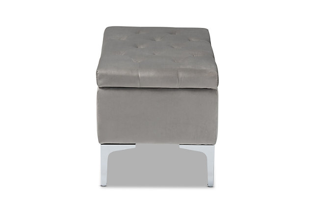 With its functional utility and luxurious style, the Mabel ottoman meets a variety of needs while also looking fabulous. Padded with foam underneath a layer of lavish gray velvet, this piece is soft to the touch and designed to maximize comfort. The ottoman features elaborate button tufting for a modern look. Raised to a practical height by a silvertone metal leg at each corner, this versatile piece can be used as a footrest or extra seating, while also serving as a storage cabinet for busy areas.Contemporary style | Made of velvet, wood, metal and foam | Silvertone legs | Upholstered in gray velvet polyester fabric; foam padding | Lift-up storage compartment | Imported | Assembly required