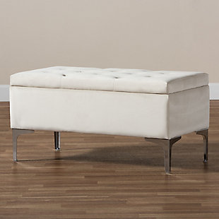 With its functional utility and luxurious style, the Mabel ottoman meets a variety of needs while also looking fabulous. Padded with foam underneath a layer of lavish beige velvet, this piece is soft to the touch and designed to maximize comfort. The ottoman features elaborate button tufting for a modern look. Raised to a practical height by a silvertone metal leg at each corner, this versatile piece can be used as a footrest or extra seating, while also serving as a storage cabinet for busy areas.Contemporary style | Made of velvet, wood, metal and foam | Silvertone legs | Upholstered in beige velvet polyester fabric; foam padding | Lift-up storage compartment | Imported | Assembly required