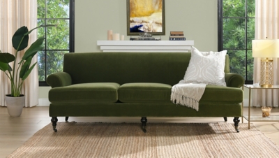 Olive green sofa in living room with decor