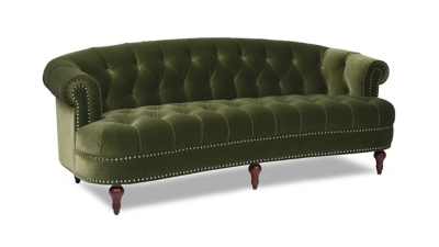 curved green velvet sofa with nailhead trim view from side