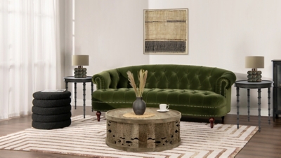 Olive green velvet Chesterfield sofa in living room with art