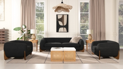 Modern black textured sofa with two armchairs in a bright room