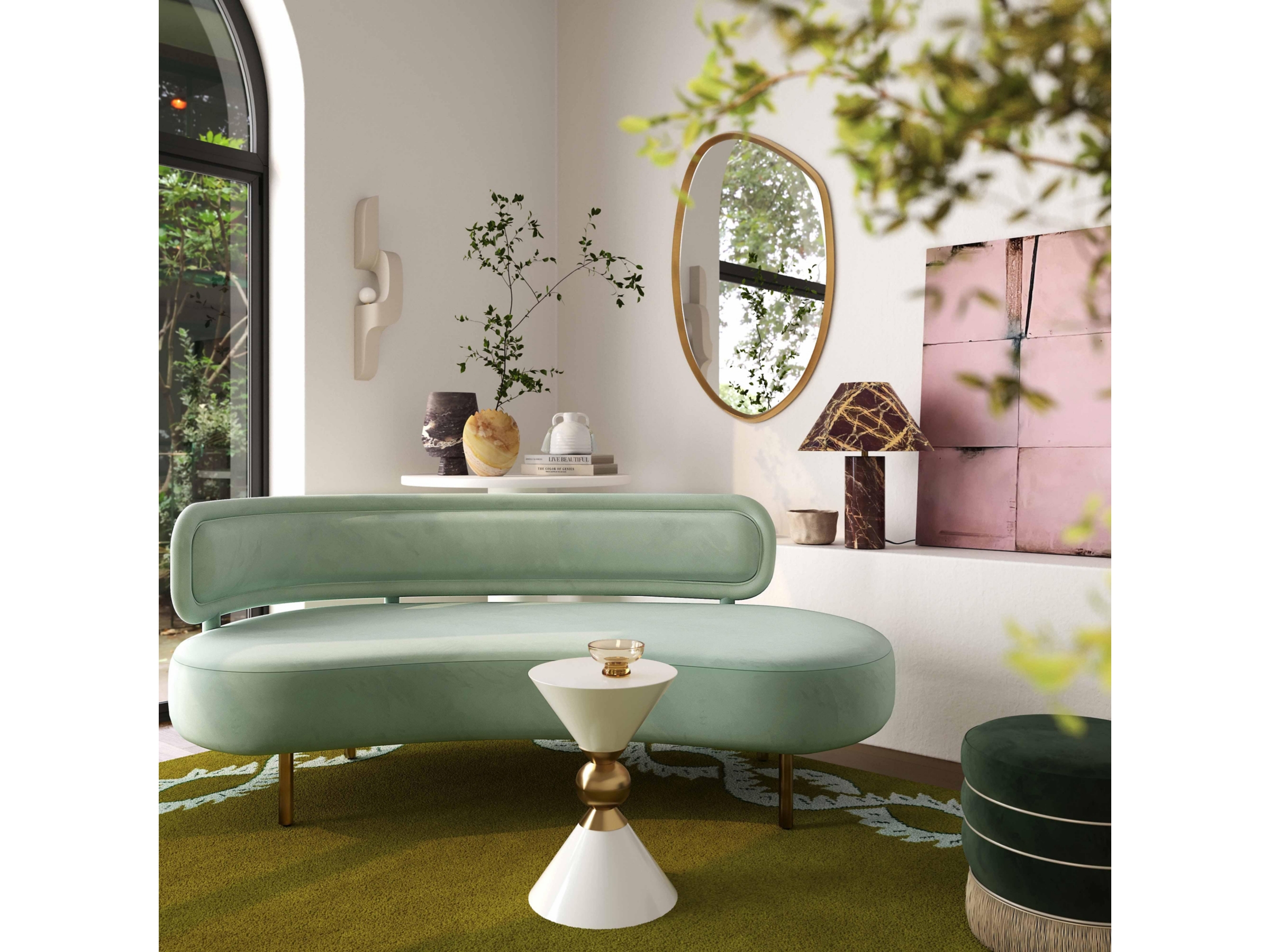Mint green curved sofa in a stylish room with decor