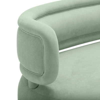 Close-up of green sofa armrest and seam stitching