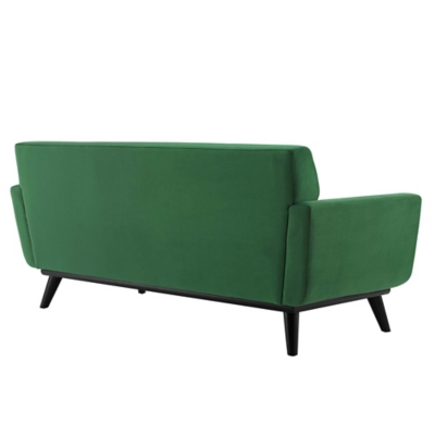 Rear/side view of the green sofa showing legs