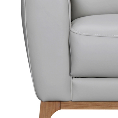 Close-up of sofa arm and seat cushion seam in light gray leather