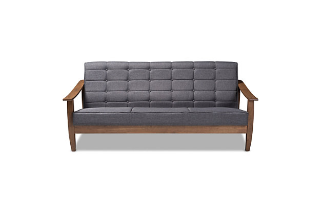 Inspired by chic mid-century Scandinavian design, this sofa is a cool addition to any space. Showcasing a sleek silhouette comprised of sloping arms and an angled back, the plush gray cushions provide comfort and complement the warm walnut-tone finish.  Mid-century inspired with biscuit tufting and tapered legs that add a vintage charm, this stylish sofa is well suited for both private living spaces and public reception areas.Rubberwood frame | Walnut-tone brown finish | Fixed cushions with gray polyester upholstery | Assembly required | Ships in 2 boxes