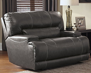Sink into the supple McCaskill power recliner and prepare to be swept off your feet—literally. Extra-wide seat and plush cushioning are divinely comfortable. The seating area is wrapped in our decadently soft leather for a luxurious experience, while a perfect leather-match upholstery on the exterior saves you money without sacrificing style. Prominent stitching, linear track arms and a goes-with-anything gray hue add stylish touches.One-touch power control recliner with adjustable positions | Corner-blocked frame with metal reinforced seat and footrest | Attached back and seat cushions | High-resiliency foam cushions wrapped in thick poly fiber | Leather interior upholstery; polyester/vinyl exterior upholstery | Power cord included; UL Listed | Excluded from promotional discounts and coupons