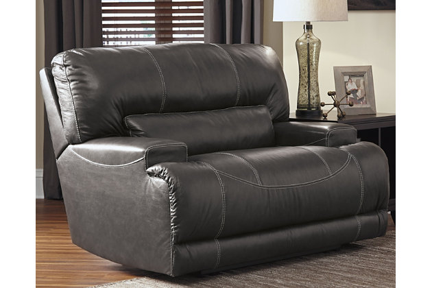 Sink into the supple McCaskill power recliner and prepare to be swept off your feet—literally. Extra-wide seat and plush cushioning are divinely comfortable. The seating area is wrapped in our decadently soft leather for a luxurious experience, while a perfect leather-match upholstery on the exterior saves you money without sacrificing style. Prominent stitching, linear track arms and a goes-with-anything gray hue add stylish touches.One-touch power control recliner with adjustable positions | Corner-blocked frame with metal reinforced seat and footrest | Attached back and seat cushions | High-resiliency foam cushions wrapped in thick poly fiber | Leather interior upholstery; polyester/vinyl exterior upholstery | Power cord included; UL Listed | Excluded from promotional discounts and coupons