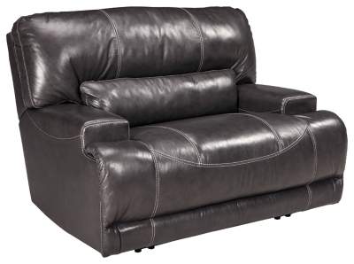 Sink into the supple McCaskill power recliner and prepare to be swept off your feet—literally. Extra-wide seat and plush cushioning are divinely comfortable. The seating area is wrapped in our decadently soft leather for a luxurious experience, while a perfect leather-match upholstery on the exterior saves you money without sacrificing style. Prominent stitching, linear track arms and a goes-with-anything gray hue add stylish touches.One-touch power control recliner with adjustable positions | Corner-blocked frame with metal reinforced seat and footrest | Attached back and seat cushions | High-resiliency foam cushions wrapped in thick poly fiber | Leather interior upholstery; polyester/vinyl exterior upholstery | Power cord included; UL Listed | Excluded from promotional discounts and coupons