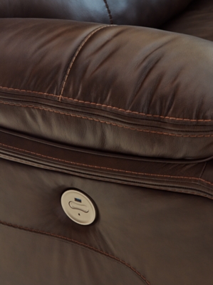 Close-up of brown leather recliner seat with visible stitching and power button control