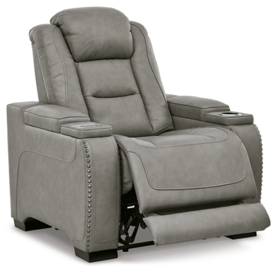 Reserved for him and made for her, The Man-Den power recliner in gray delivers all the comfort and style you could ask for. Inspired by sports car interiors, the seating area is covered in real leather for your pleasure, with a “perforated automotive” treatment for that much more appeal. Positioned at your fingertips, the advanced one-touch power control puts you in the driver’s seat with everything from an Easy View™ power headrest and power lumbar support, to a USB port and wireless charging for your phone. And with an integrated cup holder and hidden storage compartments under the posh, padded armrests, this designer power recliner makes the most of every inch of space.One-touch power control with Easy View™ power adjustable headrest, power lumbar support, USB charging and wireless phone charging | Wireless charger accommodates later model smartphones, including Apple iPhone, Samsung Galaxy, Huawei Mate and Nokia Lumia | Corner-blocked frame with metal reinforced seat | Attached cushions | 43" high back | High-resiliency foam cushions wrapped in thick poly fiber | Leather interior upholstery (with perforated details); vinyl/polyester exterior upholstery | Each armrest includes storage compartment | Cup holder (with 2 layers to accommodate drink containers) | Extended ottoman for enhanced comfort | Nailhead trim | Power cord included; UL Listed | Estimated Assembly Time: 15 Minutes