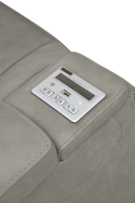 Reserved for him and made for her, The Man-Den power recliner in gray delivers all the comfort and style you could ask for. Inspired by sports car interiors, the seating area is covered in real leather for your pleasure, with a “perforated automotive” treatment for that much more appeal. Positioned at your fingertips, the advanced one-touch power control puts you in the driver’s seat with everything from an Easy View™ power headrest and power lumbar support, to a USB port and wireless charging for your phone. And with an integrated cup holder and hidden storage compartments under the posh, padded armrests, this designer power recliner makes the most of every inch of space.One-touch power control with Easy View™ power adjustable headrest, power lumbar support, USB charging and wireless phone charging | Wireless charger accommodates later model smartphones, including Apple iPhone, Samsung Galaxy, Huawei Mate and Nokia Lumia | Corner-blocked frame with metal reinforced seat | Attached cushions | 43" high back | High-resiliency foam cushions wrapped in thick poly fiber | Leather interior upholstery (with perforated details); vinyl/polyester exterior upholstery | Each armrest includes storage compartment | Cup holder (with 2 layers to accommodate drink containers) | Extended ottoman for enhanced comfort | Nailhead trim | Power cord included; UL Listed | Estimated Assembly Time: 15 Minutes