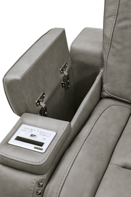 Reserved for him and made for her, The Man-Den power reclining loveseat in gray delivers all the comfort and style you could ask for. Inspired by sports car interiors, the seating area is covered in real leather for your pleasure, with a “perforated automotive” treatment for that much more appeal. Positioned at your fingertips, the advanced one-touch power control puts you in the driver’s seat with everything from an Easy View™ power headrest and power lumbar support, to a USB port and wireless charging for your phone. Talk about fully loaded. And with integrated cup holders and hidden storage compartments under the posh, padded armrests, this designer power reclining loveseat makes the most of every inch of space.Dual-sided recliner | One-touch power control with Easy View™ power adjustable headrest, power lumbar support, USB charging and wireless phone charging | Wireless charger accommodates later model smartphones, including Apple iPhone, Samsung Galaxy, Huawei Mate and Nokia Lumia | Corner-blocked frame with metal reinforced seat | Attached cushions | 43" high back | High-resiliency foam cushions wrapped in thick poly fiber | Leather interior upholstery (with perforated details); vinyl/polyester exterior upholstery | Storage console with 2 cup holders (with 2 layers to accommodate drink containers) | Each armrest includes storage compartment | Extended ottoman for enhanced comfort | Nailhead trim | Power cord included; UL Listed | Estimated Assembly Time: 15 Minutes