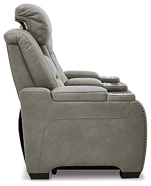 Reserved for him and made for her, The Man-Den power reclining loveseat in gray delivers all the comfort and style you could ask for. Inspired by sports car interiors, the seating area is covered in real leather for your pleasure, with a “perforated automotive” treatment for that much more appeal. Positioned at your fingertips, the advanced one-touch power control puts you in the driver’s seat with everything from an Easy View™ power headrest and power lumbar support, to a USB port and wireless charging for your phone. Talk about fully loaded. And with integrated cup holders and hidden storage compartments under the posh, padded armrests, this designer power reclining loveseat makes the most of every inch of space.Dual-sided recliner | One-touch power control with Easy View™ power adjustable headrest, power lumbar support, USB charging and wireless phone charging | Wireless charger accommodates later model smartphones, including Apple iPhone, Samsung Galaxy, Huawei Mate and Nokia Lumia | Corner-blocked frame with metal reinforced seat | Attached cushions | 43" high back | High-resiliency foam cushions wrapped in thick poly fiber | Leather interior upholstery (with perforated details); vinyl/polyester exterior upholstery | Storage console with 2 cup holders (with 2 layers to accommodate drink containers) | Each armrest includes storage compartment | Extended ottoman for enhanced comfort | Nailhead trim | Power cord included; UL Listed | Estimated Assembly Time: 15 Minutes