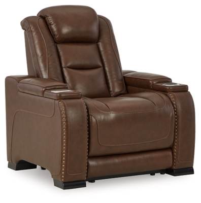 Reserved for him and made for her, this mahogany hued power recliner delivers all the comfort and style you could ask for. Inspired by sports car interiors, the Man-Den power recliner features real leather in the seating area for your pleasure. The advanced one-touch power control puts you in the driver’s seat with an adjustable headrest and lumbar support, USB port and wireless charging for your phone, plus an integrated cup holder, all at your fingertips. This power recliner utilizes every inch of space, with hidden storage compartments under the padded armrests.One-touch power control with Easy View™ power adjustable headrest, power lumbar support, USB charging and wireless phone charging | Wireless charger accommodates later model smartphones, including Apple iPhone, Samsung Galaxy, Huawei Mate and Nokia Lumia | Corner-blocked frame with metal reinforced seat | Attached cushions | High-resiliency foam cushions wrapped in thick poly fiber | Leather interior upholstery (with perforated details); vinyl/polyester (faux leather) exterior upholstery | Armrest with storage compartment | 2 cup holders | 43" high back | Extended ottoman for enhanced comfort | Nailhead trim | Power cord included; UL Listed | Estimated Assembly Time: 15 Minutes