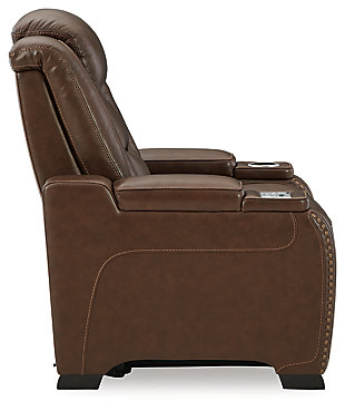 Reserved for him and made for her, this mahogany hued power recliner delivers all the comfort and style you could ask for. Inspired by sports car interiors, the Man-Den power recliner features real leather in the seating area for your pleasure. The advanced one-touch power control puts you in the driver’s seat with an adjustable headrest and lumbar support, USB port and wireless charging for your phone, plus an integrated cup holder, all at your fingertips. This power recliner utilizes every inch of space, with hidden storage compartments under the padded armrests.One-touch power control with Easy View™ power adjustable headrest, power lumbar support, USB charging and wireless phone charging | Wireless charger accommodates later model smartphones, including Apple iPhone, Samsung Galaxy, Huawei Mate and Nokia Lumia | Corner-blocked frame with metal reinforced seat | Attached cushions | High-resiliency foam cushions wrapped in thick poly fiber | Leather interior upholstery (with perforated details); vinyl/polyester (faux leather) exterior upholstery | Armrest with storage compartment | 2 cup holders | 43" high back | Extended ottoman for enhanced comfort | Nailhead trim | Power cord included; UL Listed | Estimated Assembly Time: 15 Minutes