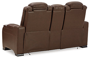 Reserved for him and made for her, this mahogany hued power reclining loveseat delivers all the comfort and style you could ask for. Inspired by sports car interiors, the Man-Den power reclining loveseat with console features real leather in the seating area for your pleasure with high-end accents for that much more appeal. The advanced one-touch power control puts you in the driver’s seat with an adjustable headrest and lumbar support, USB port and wireless charging for your phone, all at your fingertips. The center console includes two illuminated cup holders and a storage compartment. This power recliner makes the most of every inch of space, with hidden storage compartments under the padded armrests.Dual-sided recliner | One-touch power control with Easy View™ power adjustable headrest, power lumbar support, USB charging and wireless phone charging | Wireless charger accommodates later model smartphones, including Apple iPhone, Samsung Galaxy, Huawei Mate and Nokia Lumia | Corner-blocked frame with metal reinforced seat | Attached cushions | High-resiliency foam cushions wrapped in thick poly fiber | Leather interior upholstery (with perforated details); vinyl/polyester exterior upholstery | Storage console with 2 cup holders | 43" high back | Armrest with storage compartment | Extended ottoman for enhanced comfort | Nailhead trim | Power cord included; UL Listed | Estimated Assembly Time: 15 Minutes