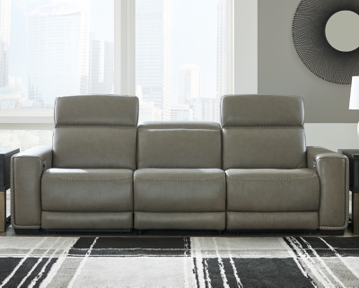 Truly putting high design into recline, the Correze power sofa with genuine leather seating area proves that just because you’re a recliner doesn’t mean you have to look like one. Deceptively beautiful, its ultra clean-lined aesthetic is as cool and contemporary as they come. Low-profile back has a super swank look. When you need more support for your head and neck, the press of a button engages the Easy View™ power adjustable headrest, designed to let you lean back and still have a primo view of the TV. Ever-so-subtle curves and stunning stitching perfect the aesthetic.Includes 3 pieces: armless chair, left-arm facing zero wall power recliner and right-arm facing zero wall power recliner | One-touch power control with adjustable positions, Easy View™ adjustable headrest and zero-draw USB plug-in | Zero-draw technology only consumes power when the USB receptacle is in use | Zero wall design requires minimal space between wall and chair back | Corner-blocked frame with metal reinforced seat | Attached back and seat cushions | High-resiliency foam cushions wrapped in thick poly fiber | Extended ottoman for enhanced comfort | Leather interior upholstery; vinyl/polyester exterior upholstery    | Power cord included; UL Listed | Exposed feet with faux wood finish | "Left-arm" and "right-arm" describe the position of the arm when you face the piece | Estimated Assembly Time: 55 Minutes