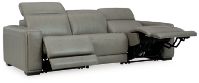 Truly putting high design into recline, the Correze power sofa with genuine leather seating area proves that just because you’re a recliner doesn’t mean you have to look like one. Deceptively beautiful, its ultra clean-lined aesthetic is as cool and contemporary as they come. Low-profile back has a super swank look. When you need more support for your head and neck, the press of a button engages the Easy View™ power adjustable headrest, designed to let you lean back and still have a primo view of the TV. Ever-so-subtle curves and stunning stitching perfect the aesthetic.Includes 3 pieces: armless chair, left-arm facing zero wall power recliner and right-arm facing zero wall power recliner | One-touch power control with adjustable positions, Easy View™ adjustable headrest and zero-draw USB plug-in | Zero-draw technology only consumes power when the USB receptacle is in use | Zero wall design requires minimal space between wall and chair back | Corner-blocked frame with metal reinforced seat | Attached back and seat cushions | High-resiliency foam cushions wrapped in thick poly fiber | Extended ottoman for enhanced comfort | Leather interior upholstery; vinyl/polyester exterior upholstery    | Power cord included; UL Listed | Exposed feet with faux wood finish | "Left-arm" and "right-arm" describe the position of the arm when you face the piece | Estimated Assembly Time: 55 Minutes