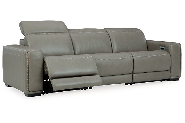 Truly putting high design into recline, the Correze power sofa with genuine leather seating area proves that just because you’re a recliner doesn’t mean you have to look like one. Deceptively beautiful, its ultra clean-lined aesthetic is as cool and contemporary as they come. Low-profile back has a super swank look. When you need more support for your head and neck, the press of a button engages the Easy View™ power adjustable headrest, designed to let you lean back and still have a primo view of the TV. Ever-so-subtle curves and stunning stitching perfect the aesthetic.Includes 3 pieces: armless chair, left-arm facing zero wall power recliner and right-arm facing zero wall power recliner | One-touch power control with adjustable positions, Easy View™ adjustable headrest and zero-draw USB plug-in | Zero-draw technology only consumes power when the USB receptacle is in use | Zero wall design requires minimal space between wall and chair back | Corner-blocked frame with metal reinforced seat | Attached back and seat cushions | High-resiliency foam cushions wrapped in thick poly fiber | Extended ottoman for enhanced comfort | Leather interior upholstery; vinyl/polyester exterior upholstery    | Power cord included; UL Listed | Exposed feet with faux wood finish | "Left-arm" and "right-arm" describe the position of the arm when you face the piece | Estimated Assembly Time: 55 Minutes