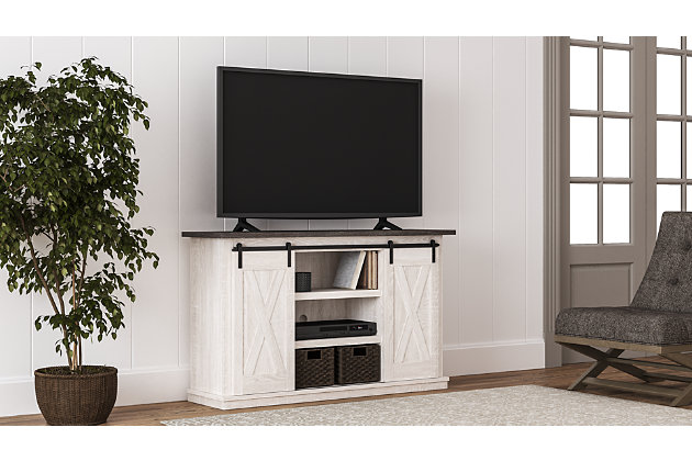 With its two-tone finish, cross-buck details and authentic charm, the Dorrinson TV stand is right in tune with your relaxed approach to high style. Beautifully made to accommodate your media equipment, it’s well equipped with adjustable shelving, cutouts for wire management and, of course, a pair of sliding barn doors you can center or place to the side. What a mastery in modern farmhouse living.Made of engineered wood and decorative laminate | Antique white finish | Top with replicated gray wood grain | Metal brackets and hardware | Pair of sliding barn doors | 2 adjustable center shelves; 4 side shelves | Cross-buck details | Cutouts for wire management | Assembly required | Estimated Assembly Time: 60 Minutes