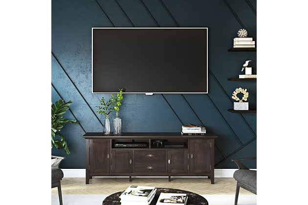 This rustic, extra-wide TV stand with Shaker-style doors makes a stylish and functional base for your home entertainment system. Crafted of solid wood, this piece features both open and closed storage options, elegantly tapered legs and a tabletop with crown-edged moulding. The media stand is perfectly sized for TVs up to 80 inches, with plenty of storage space for all your media and gaming devices.DIMENSIONS: 16.5" D x 72" W x 26" H | Handcrafted with care using the finest quality solid wood | Hand-finished in Brunette Brown with a protective NC lacquer to accentuate and highlight the grain and the uniqueness of each piece of furniture | Features a large centrally located open area with two open spaces, two (2) drawers as well as two (2) framed doors with enclosed spaces; the two (2) large side storage cabinets open to one (1) adjustable shelf each. | Extra wide TV Stand is perfect for TVs up to 80 inches includes cord management cut-outs for easy installation of TV and media components | Transitional Style includes molded crown edged table top and Antique Brass pulls and knobs | Assembly Required | We believe in creating excellent, high quality products made from the finest materials at an affordable price. Every one of our products come with a 1-year warranty and easy returns if you are not satisfied. | Cutouts for cord management | Assembly required