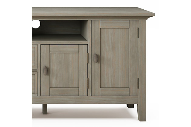 This rustic, extra-wide TV stand with Shaker-style doors makes a stylish and functional base for your home entertainment system. Crafted of solid wood, it features both open and closed storage options, elegantly tapered legs and a tabletop with crown-edged moulding. The media stand is perfectly sized for TVs up to 80 inches, with plenty of storage space for all your media and gaming devices.DIMENSIONS: 16.5" D x 72" W x 26" H | Handcrafted with care using the finest quality solid wood | Hand-finished in Distressed Grey with a protective NC lacquer to accentuate and highlight the grain and the uniqueness of each piece of furniture | Features a large centrally located open area with two open spaces, two (2) drawers as well as two (2) framed doors with enclosed spaces; the two (2) large side storage cabinets open to one (1) adjustable shelf each. | Extra wide TV Stand is perfect for TVs up to 80 inches includes cord management cut-outs for easy installation of TV and media components | Transitional Style includes molded crown edged table top and Antique Brass pulls and knobs | Assembly Required | We believe in creating excellent, high quality products made from the finest materials at an affordable price. Every one of our products come with a 1-year warranty and easy returns if you are not satisfied. | Weight capacity 220 lbs. | Cutouts for cord management | Assembly required