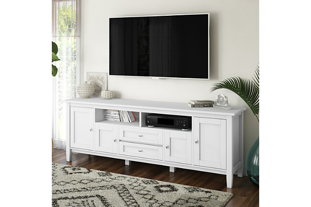 This rustic, extra-wide TV stand with Shaker-style doors makes a stylish and functional base for your home entertainment system. Crafted of solid wood, this piece features both open and closed storage options, elegantly tapered legs and a tabletop with crown-edged moulding. The media stand is perfectly sized for TVs up to 80 inches, with plenty of storage space for all your media and gaming devices.DIMENSIONS: 17.5" d x 72" w x 26" h | Handcrafted with care using the finest quality solid wood | Hand-finished in a White Painted Finish and a protective NC lacquer | Features central open area with one (1) drawer, one (1) compartment with flip down door, two (2) framed doors with enclosed spaces & two (2) large side storage cabinets open to one (1) adjustable shelf each | Extra wide TV Stand is perfect for TVs up to 80 inches, includes cord management cut-outs for easy installation of TV and media components. | Transitional design includes shaker style doors, Brushed Nickel knobs, square tapered legs and square edged table top | Assembly Required | We believe in creating excellent, high quality products made from the finest materials at an affordable price. Every one of our products come with a 1-year warranty and easy returns if you are not satisfied. | Cutouts for cord management | Assembly required