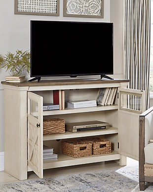 Whether your style is farmhouse fresh, shabby chic or country cottage, you’ll find the Bolanburg medium TV stand perfectly in tune. Its two-tone finish pairs a trendy textured antique white with a weathered gray for that much more quaint character. Charming elements include crossbuck adorned cabinet doors with glass inlays for peek-through flair. Ample adjustable shelving and cutouts for wire management nicely accommodate your media needs.Made of veneers, wood and engineered wood | 2 cabinet doors with glass inlays | 2 adjustable shelves | Cutouts for wire management | Two-tone finish: textured antique white and weathered gray | Black iron-tone hardware | Assembly required | Estimated Assembly Time: 45 Minutes