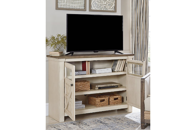Whether your style is farmhouse fresh, shabby chic or country cottage, you’ll find the Bolanburg medium TV stand perfectly in tune. Its two-tone finish pairs a trendy textured antique white with a weathered gray for that much more quaint character. Charming elements include crossbuck adorned cabinet doors with glass inlays for peek-through flair. Ample adjustable shelving and cutouts for wire management nicely accommodate your media needs.Made of veneers, wood and engineered wood | 2 cabinet doors with glass inlays | 2 adjustable shelves | Cutouts for wire management | Two-tone finish: textured antique white and weathered gray | Black iron-tone hardware | Assembly required | Estimated Assembly Time: 45 Minutes