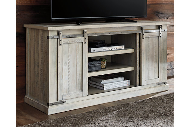 A brilliant rendition of modern farmhouse style (sliding barn doors and all), the Carynhurst TV stand is right in tune with your richly relaxed sense of style. The TV stand’s clean yet hearty profile is enhanced with a complex whitewash finish with charming distressing and plank-effect styling. Antiqued gray metal hardware is a sophisticated complement.Made of pine wood, veneers and engineered wood | Whitewash finish | Plank effect styling | Pair of sliding barn doors | 2 adjustable center shelves | 4 side shelves | Metal brackets and hardware in antiqued gray finish | Cutouts for wire management | Assembly required | Estimated Assembly Time: 30 Minutes
