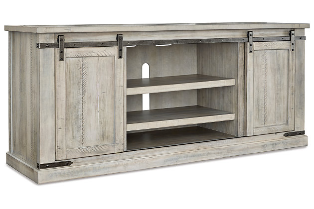 A brilliant rendition of modern farmhouse style (sliding barn doors and all), the Carynhurst TV stand is right in tune with your richly relaxed sense of style. The TV stand’s clean yet hearty profile is enhanced with a complex whitewash finish with charming distressing and plank-effect styling. Antiqued gray metal hardware is a sophisticated complement.Made of pine wood, veneers and engineered wood | Whitewash finish | Plank effect styling | Pair of sliding barn doors | 2 adjustable center shelves | 4 side shelves | Metal brackets and hardware in antiqued gray finish | Cutouts for wire management | Assembly required | Estimated Assembly Time: 30 Minutes